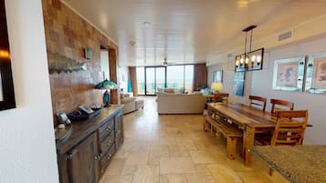 A spacious kitchen with a dining area, large windows, and a view of the outdoors.