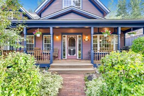 Charming two-story house with a traditional front porch and welcoming entrance.