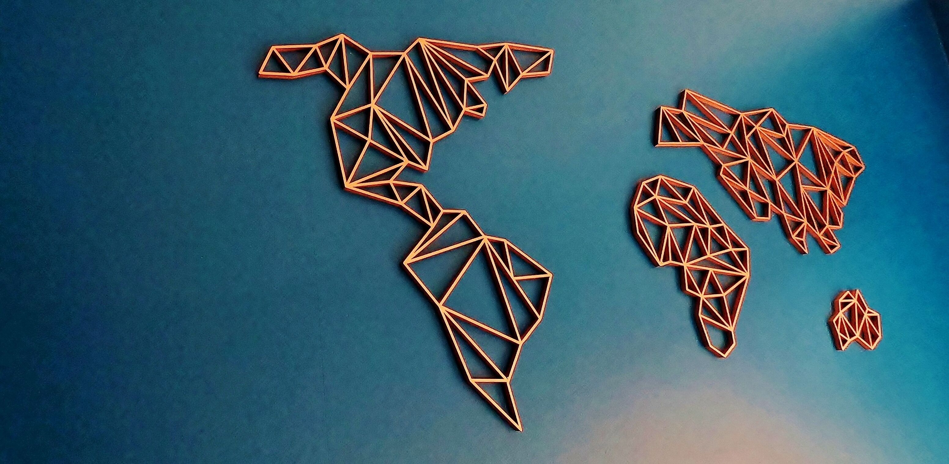 A geometric map of the Americas made of interconnected lines and shapes.