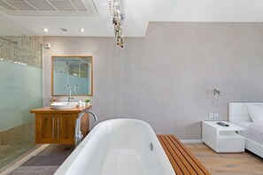 A modern bathroom with a freestanding bathtub, a wooden vanity, and a glass shower enclosure. - Lagoon Amazing water front 3 (Herzliya)