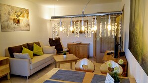 A cozy living room with a sofa, coffee table, and decorative items. - Residenz Schauinsland (Todtnau)