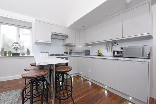 Percy Street Penthouse Apartment | Private kitchen | Full-size fridge, microwave, oven, stovetop