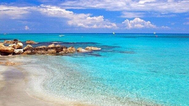 A beach with clear turquoise water, rocky formations, and a sandy shore. - Imagine Your Family Renting a Luxury Holiday Villa Close to Sotira’ Main Attractions (Sotira)