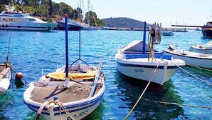 A marina with several boats docked in clear blue water.