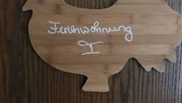 A wooden cutout of a bird with the text "Ferienschwung" on it.
