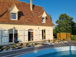 A two-story house with a swimming pool, white shutters, and a garden with rocks and plants. - Holiday Home in Blis et Born, Near  Perigueux, Dordogne - Large Heated Swimming (Bassillac Et Auberoche)