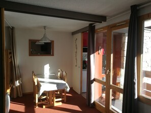 Enjoy meals with family and friends in this dining area, featuring a table for four and comfortable seating.