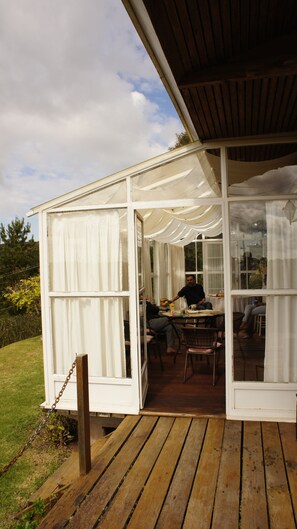 Enjoy meals in this garden conservatory with a dining area and seating for guests.