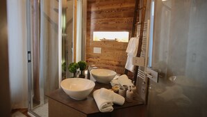 A bathroom with wooden paneling, two large sinks, a glass shower enclosure, and a towel rack. - Epicurus guest house: Zeus (Somma Lombardo)