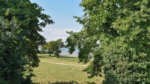 A grassy park area with trees and a fence. - 2 bedroom accommodation in St. Lawrence, near Burnham-on-Crouch (St. Lawrence, near Burnham-on-Crouch)