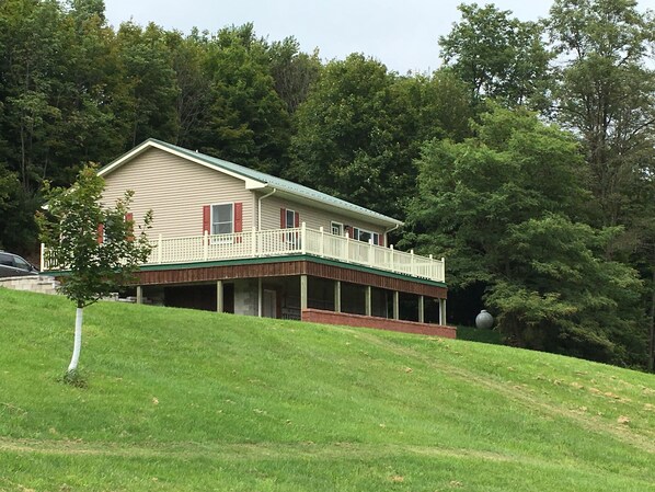 A two-story house with a covered porch and a small front yard. - Beautiful Getaway amazing views! Sleeps 6 (Dushore)