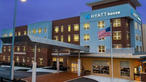 A multi-story hotel with a modern design, featuring a prominent 'Hyatt House' sign and an American flag. - Hyatt House Nashville/Franklin/Cool Springs (Franklin)