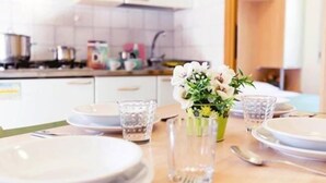 Kjøleskap, kokeplater, høy barnestol og kjøkkenutstyr