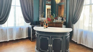 A room with a dark wooden cabinet, a white countertop, and a large mirror.