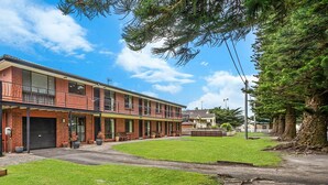 A two-story building with a flat roof, large windows, and a balcony on the upper floor. - Perfect for your beach holiday, you are only a stone's throw to the Port Fairy East Beach (Port Fairy)