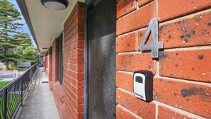 A brick building with a number '4' sign on the wall and a doorbell labeled 'Master Lock'. - Perfect for your beach holiday, you are only a stone's throw to the Port Fairy East Beach (PORT FAIRY)