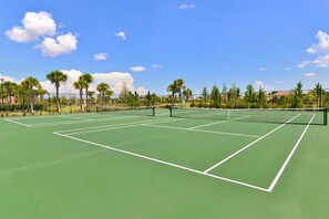 An outdoor tennis court with a clear sky and palm trees in the background. - Amazing 6bds Single Home With Private Pool St7040 (Davenport)