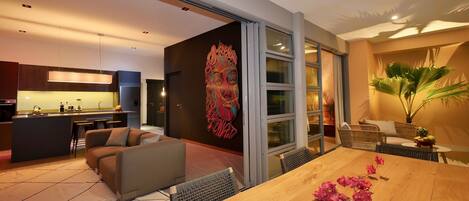 A modern living space with a kitchen, dining area, and seating area.