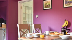 A dining area with a table set for breakfast, including croissants, juice, and coffee. - 2 bedroom accommodation in Horton-in-Ribblesdale, near Settle (Horton-in-Ribblesdale, near Settle)