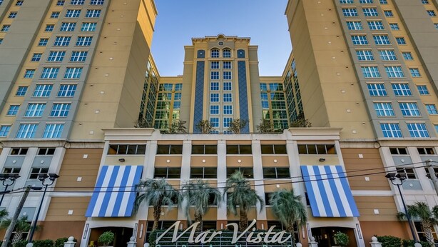 A hotel with a central tower, multiple floors, and a sign reading "Mar Vista".
