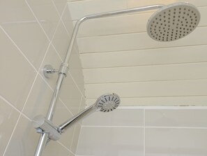 A shower with a handheld attachment and a fixed showerhead. - A truly beautiful train conversion, a stone’s throw from the River Test. (Horsebridge)