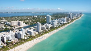 A coastal cityscape with a long beachfront, high-rise hotels, and a marina. - EPIC Escape/Pool Access Near Malls Airport Hospita (Miami)