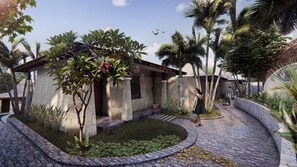 A stone building with a curved roof, surrounded by palm trees and a stone pathway. - 7 Chakras Resort (Kerobokan)