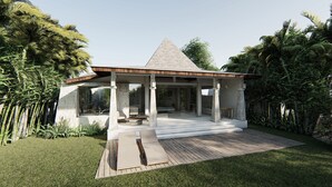 Ein modernes, offenes Pavillon mit geneigtem Dach, Steinpfeilern und einer Holzterrasse.