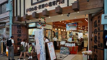 A Japanese store with wooden signage and a 'Merry Christmas' decoration.