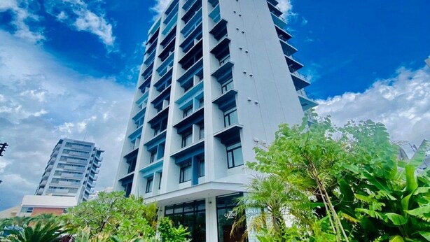 A modern high-rise building with multiple balconies and a clear sky. - Hotel Cocktail Stay Naha (Naha)