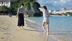 A beach with clear water, a rocky outcrop, and a bridge in the background. - Hotel Cocktail Stay Naha (Naha)