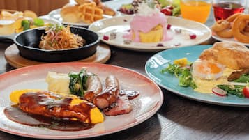 A dining table with various dishes including a steak, sausages, and a plate with a poached egg and vegetables.