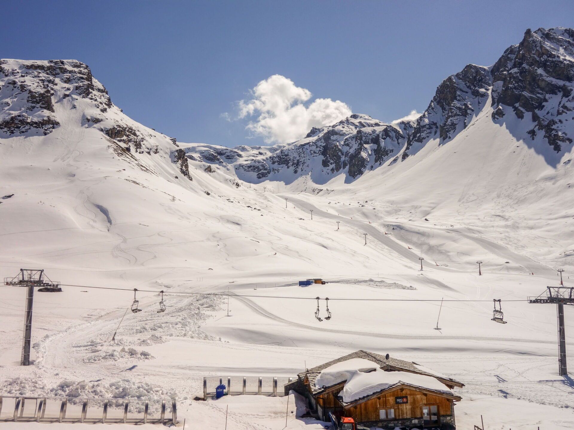 A snow-covered mountain with ski lifts and a wooden building labeled "SKI IT".