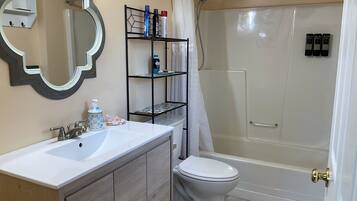 Bathtub, eco-friendly toiletries, hair dryer, towels