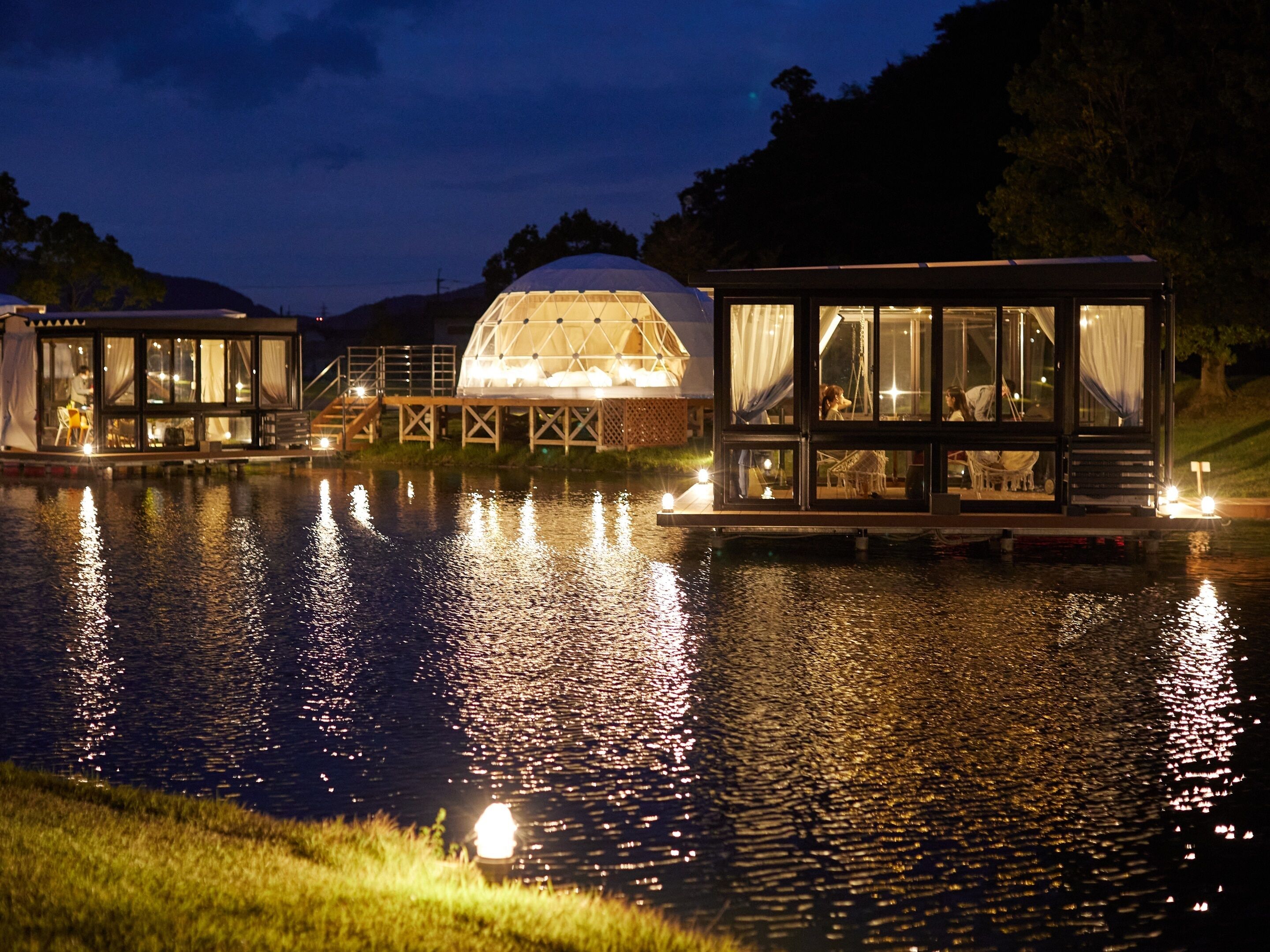 A houseboat with a glass enclosure, a dome-shaped structure, and a small deck area.