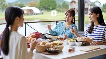 A dining table with various dishes and a scenic outdoor view.