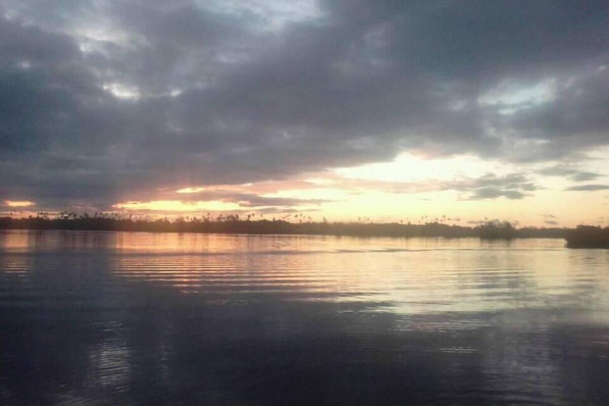 A calm body of water reflecting the sky.