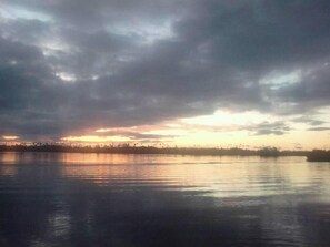 A calm body of water reflecting the sky. - Serah's Lagoon Hideaway (Auki)