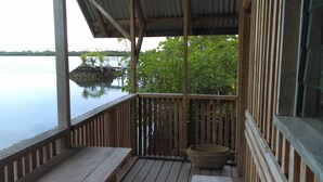 A wooden deck with a view of calm water and a distant island. - Serah's Lagoon Hideaway (Auki)