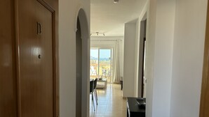 A hallway leading to a balcony with a view of the sea. - Nerja Paradise Rentals - Apartment Chimenea C1D (Nerja)