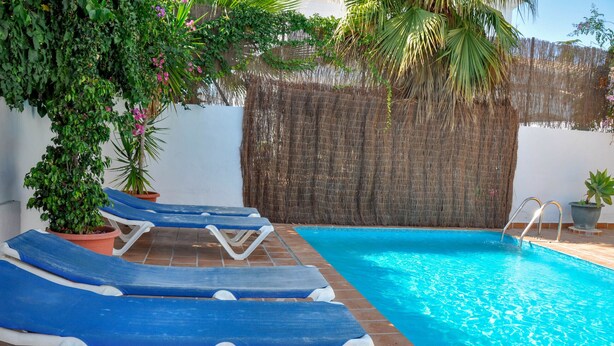 A pool area with blue lounge chairs and a small pool. - Nerja Paradise Rentals - Villa Kaisaras (Nerja)