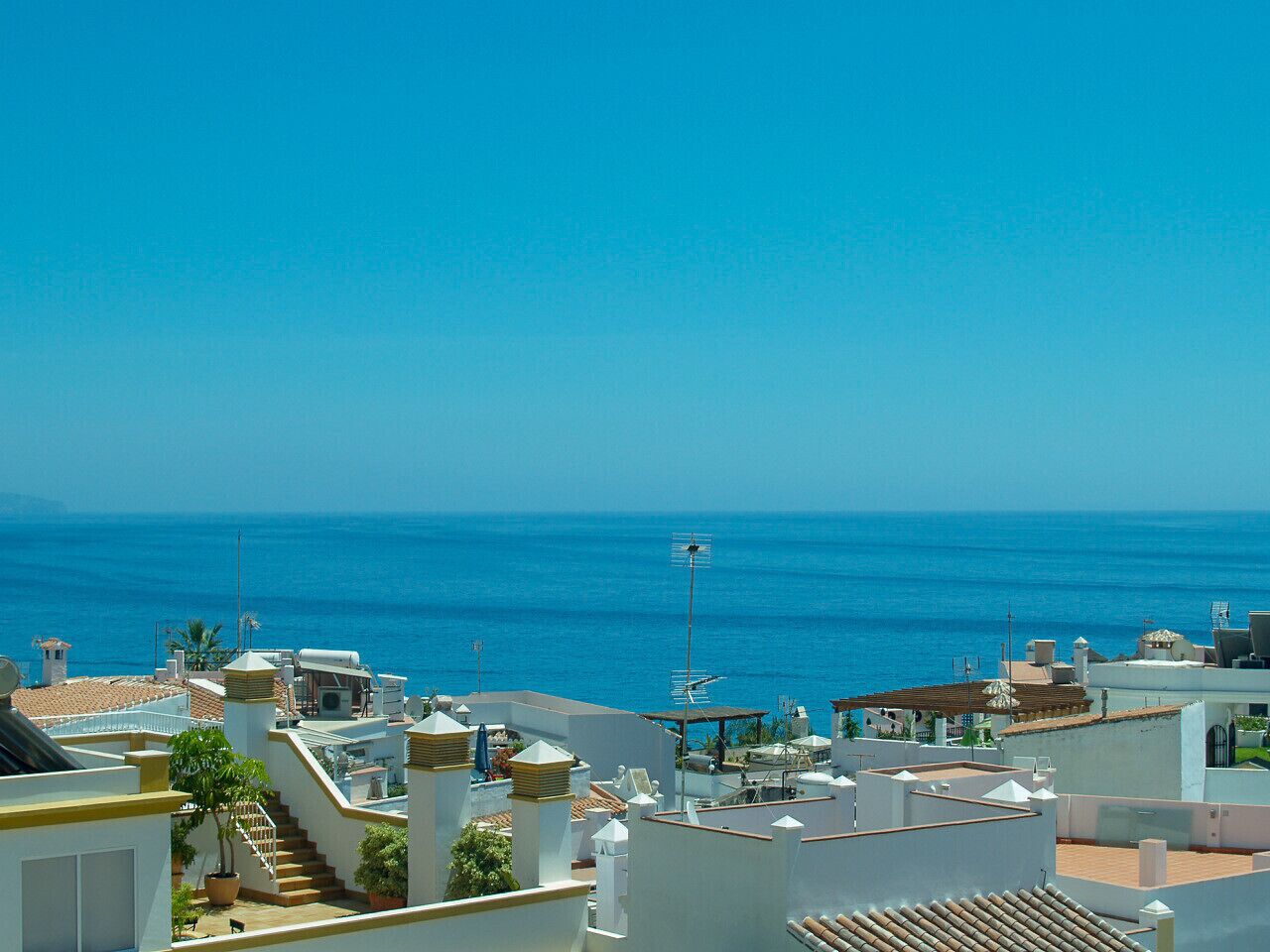 A coastal residential area with buildings overlooking the sea.