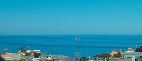 A coastal residential area with buildings overlooking the sea.