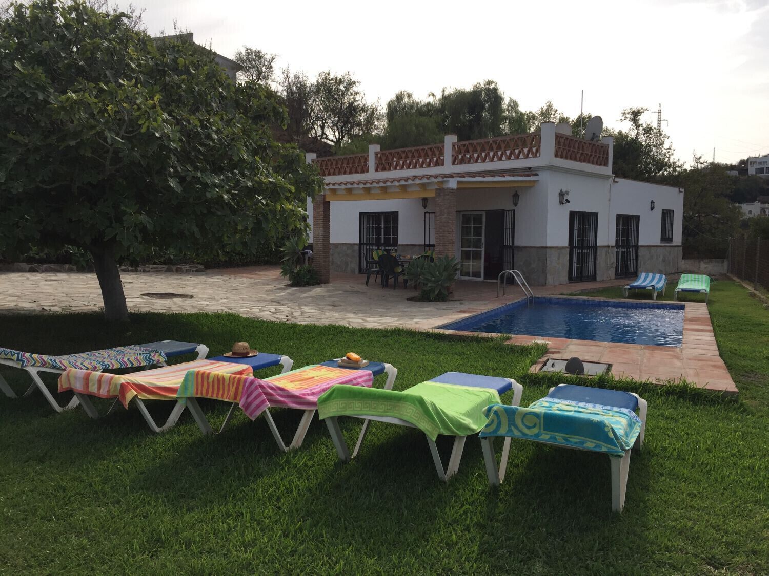 A poolside area with lounge chairs and a small pool.