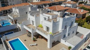A modern building with a rooftop pool, multiple balconies, and a mix of residential and commercial spaces. - Nerja Paradise Rentals - Villa Valeria (Nerja)
