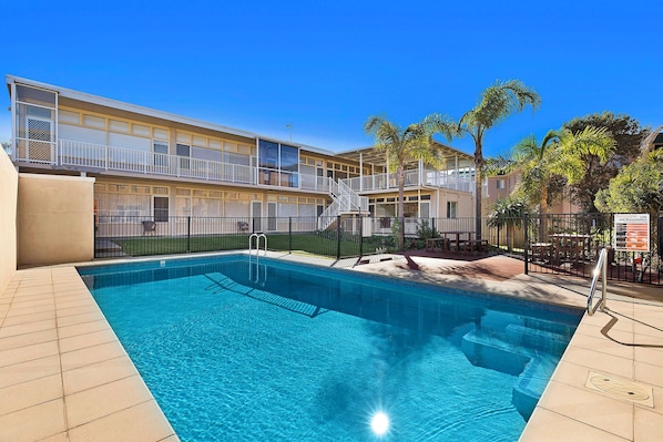 Relax by the pool surrounded by lush greenery and take in the views from the balconies.