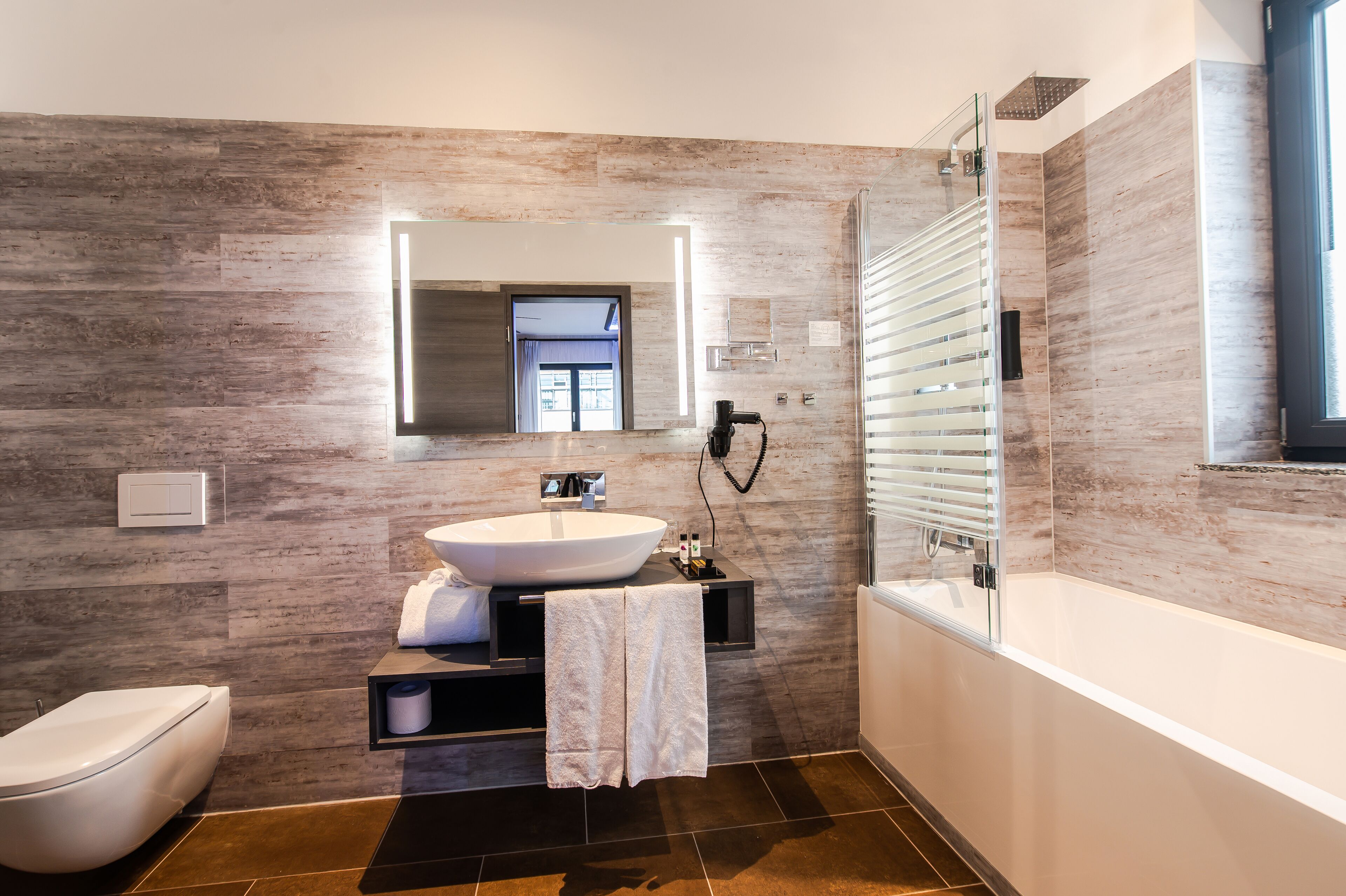 separate bathtub and shower, hair dryer, towels, soap