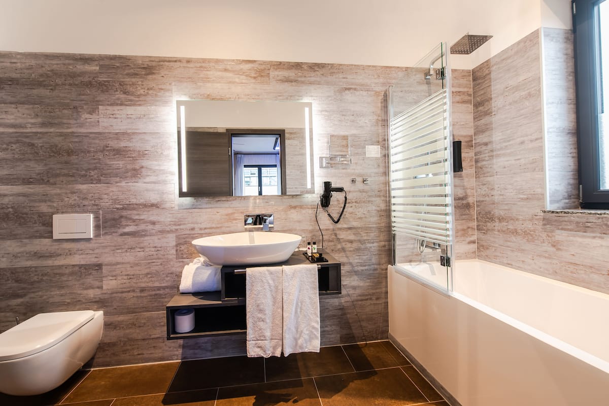 separate bathtub and shower, hair dryer, towels, soap