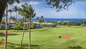 A golf course with a clear view of the ocean and a row of houses in the background. - Traveler Favorite! Spacious, comfortable, updated 5-STAR Wailea Retreat. 🏝  (Wailea)
