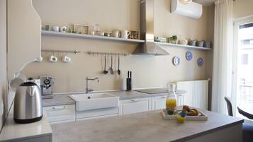 Full-sized fridge, stovetop, dishwasher, espresso maker